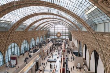 photo de l'intérieur du musée d'orsay, pris en hauteur avec des visiteurs et des oeuvres