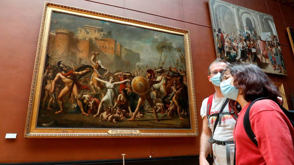 Le 6 juillet, le musée du Louvre a rouvert ses portes. Ici, deux visiteurs devant le célèbre tableau de David, "L'enlèvement des Sabines" © François Guillot / AFP