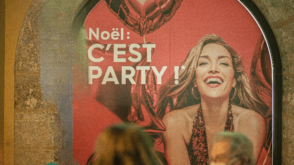 Affichage dans l'espace public : l'étoile à la suite du slogan renvoie, au bas de l'affiche, à une traduction en français d'un jeu de mot qui s'appuie sur un mot anglais.